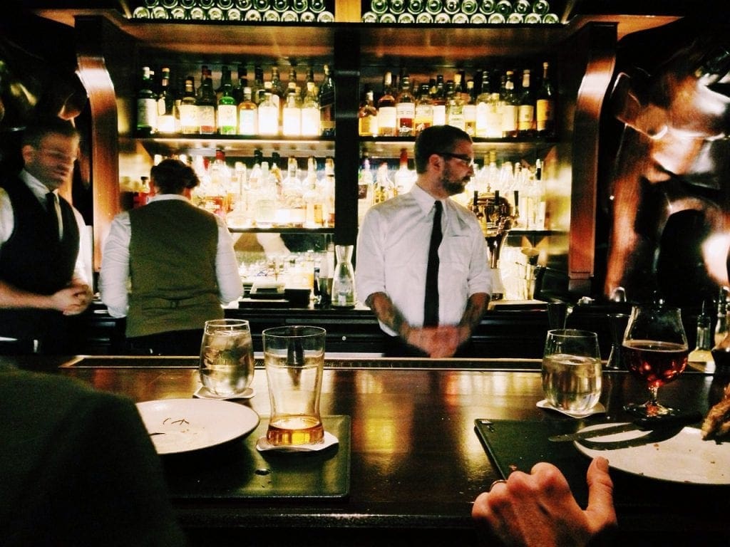 Jobs that let you travel internationally - a bartender behind the bar
